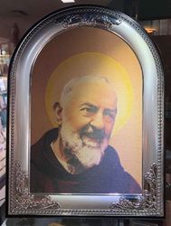 Padre Pio Canvas in Silver/Wood Frame   Beautiful full color canvas carefully mounted in a silver plated frame with solid wood backing. Can hang or stand with included back stand. Measures 13.5" tall x 10.25" wide. Gift Boxed. ?Made in Italy.